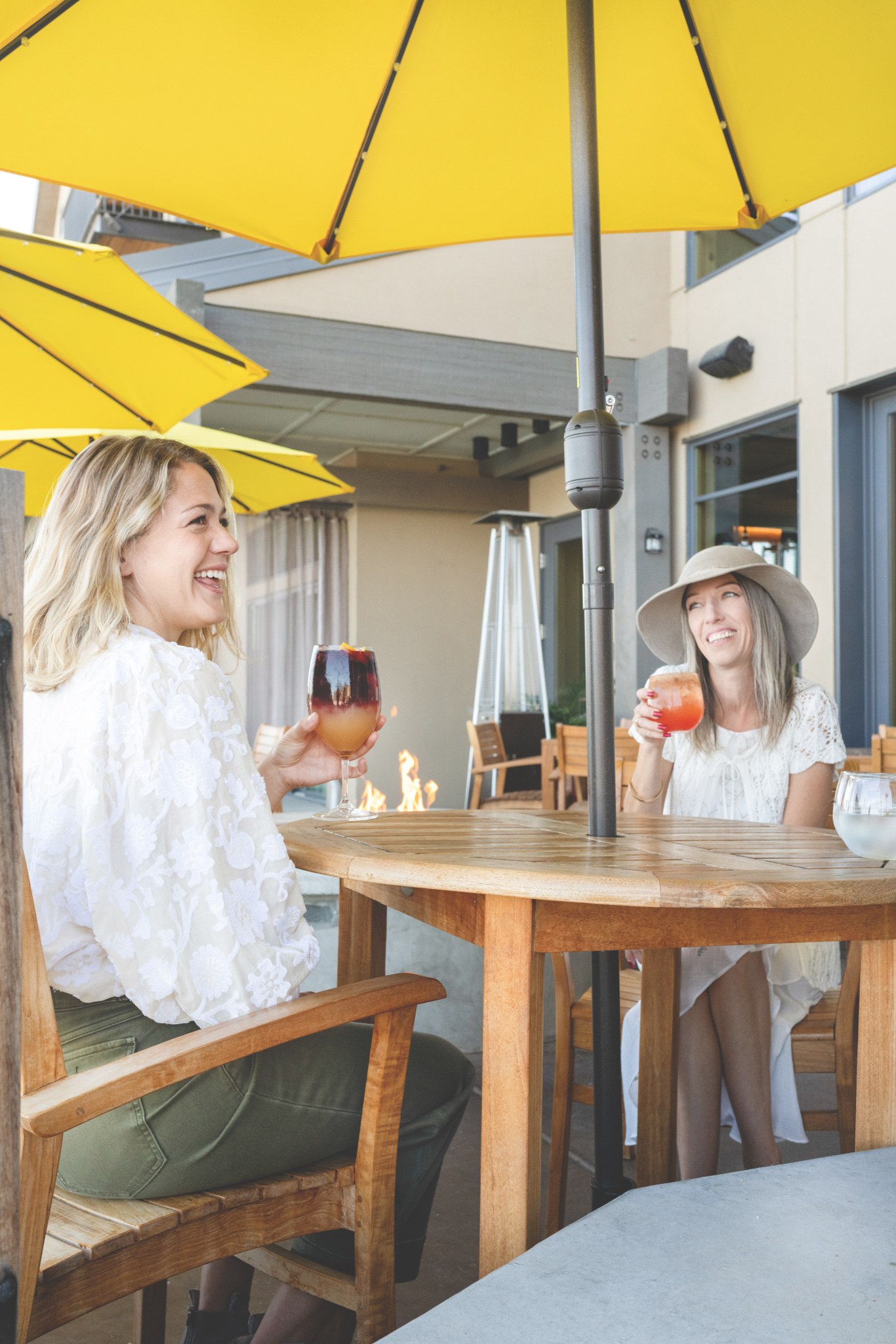Two women sitting at a table with beverages