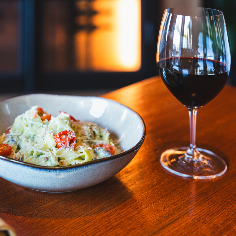 Pasta dish and glass of red wine